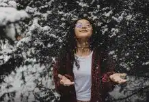 woman in white shirt touching the snow