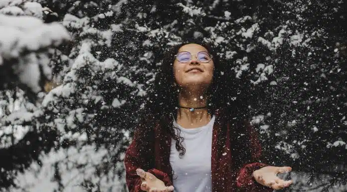 woman in white shirt touching the snow